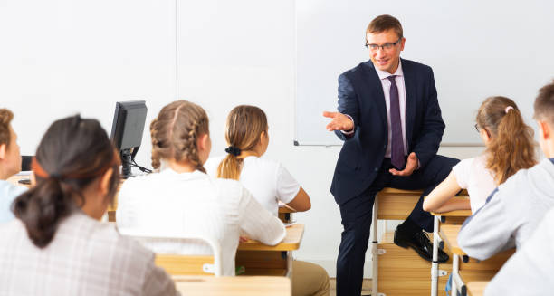 istock Teacher communicates freely with students in classroom at school 1286594741