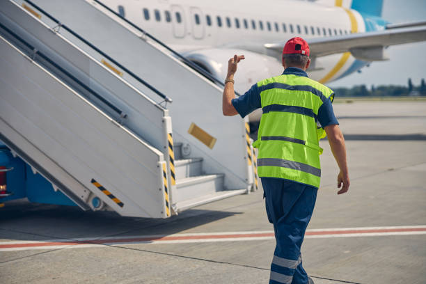 istock Supervisor guiding a vehicle operator at the airdrome 1286597589