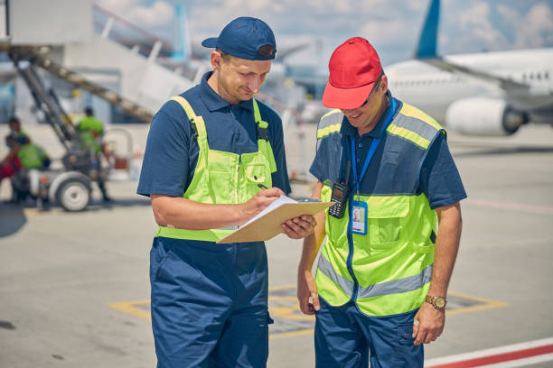 istock Two smiling men standing at the airdrome 1286597597