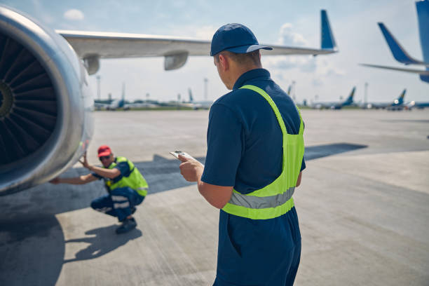 istock Aircraft maintenance mechanics working at the airdrome 1286597598