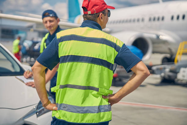 istock Airport worker standing next to his colleague 1286597603