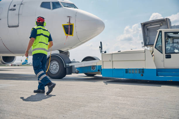 istock Man in uniform heading towards an airliner 1286597605