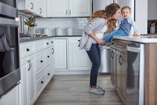 Shot of a pregnant woman and her son spending time together in the kitchen at home