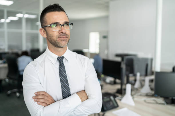 istock Successful businessman in office with hands crossed 1286598644
