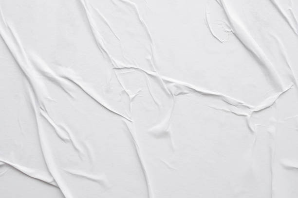 istock Blank white crumpled and creased paper poster texture background 1286598700