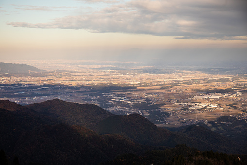 A view at sunset looking down from high elevation in the mountains over Yokkaichi and Nagoya cities.