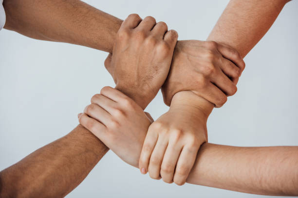 istock Cropped view of multiethnic men doing unity gesture isolated on grey 1286600828