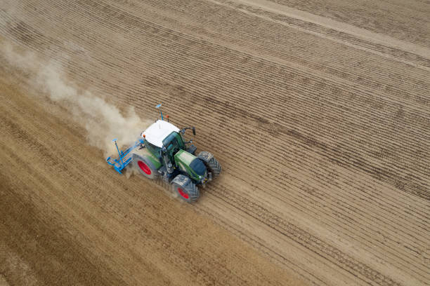 istock Tractor drilling seed in plowed field, aerial view 1286602480