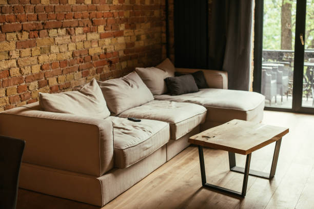 istock modern interior of living room with beige sofa, table and remote controller 1286603268