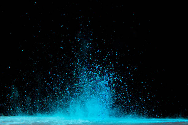 istock Explosion of blue powder on black background 1286607054