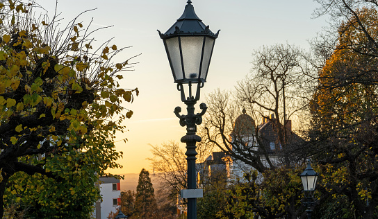 Bergisch Gladbach, Germany, 18 November 2020: Idyllic street at sunset with lanterns in the foreground