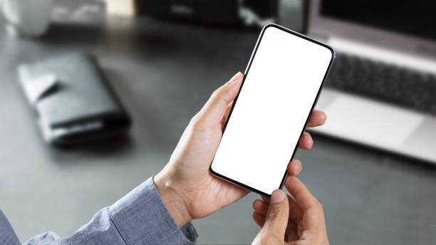 istock Holding a blank smartphone with a white background. with text space. 1286607809