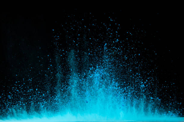 istock Explosion of blue powder on black background 1286607832