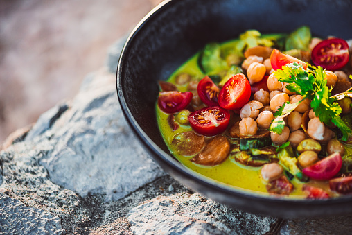 Delicious Asian Green Curry with Coconut Milk – vegan and organic with chickpeas, bell pepper, tomatoes, coriander, zucchini, ginger, garlic