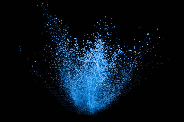 istock Explosion of blue powder on black background 1286608596