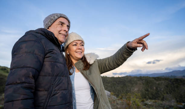 istock Happy couple hiking together and pointing away 1286610128