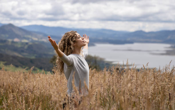 istock Woman relaxing outdoors in the countryside with arms open 1286610206