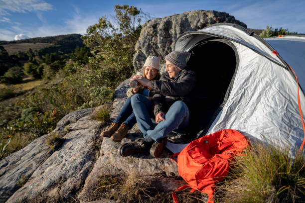 istock Loving couple camping and drinking coffee outside their tent 1286610282