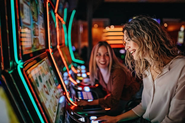 Do you know how to play Girl friends gambling in casino on slot machinery amusement arcade stock pictures, royalty-free photos & images