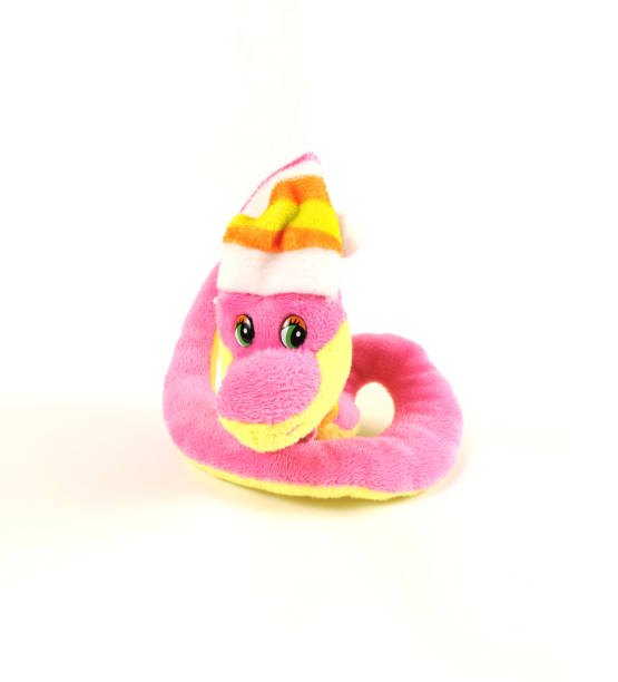 soft plush toy pink snake in a christmas cap ,   isolated on white background