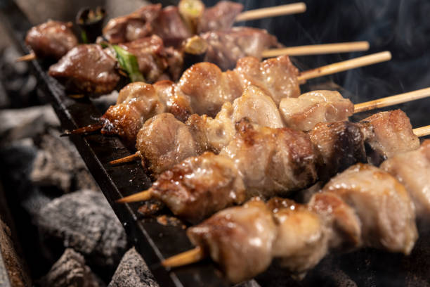 istock Chef grills yakitori, charcoal-grilled chicken 1286614503