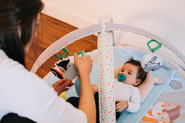 istock Mom playing with her smiling baby boy 1286616440