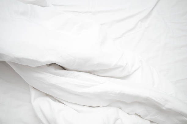 istock Top view of linel wrinkled bed. White wrinkles bedding sheets 1286617257
