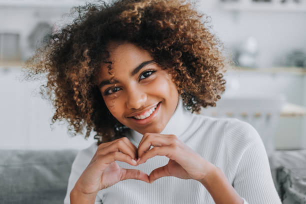 istock Young African model holds hands in heart shape near face 1286617361