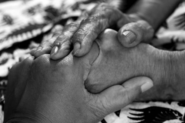 istock Human holding hands full of love affection in black and white background. 1286618844