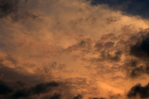 Blur background of dark dramatic sky with sunset light. Sunset sunrise sky clouds.