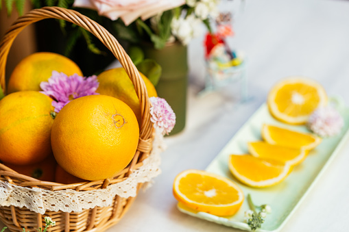 Ripe Navel orange with flowers on the table