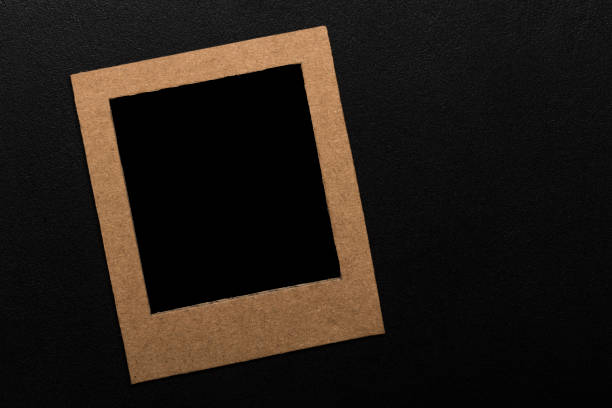istock picture frame. Kraft cardboard square frame template on black background with space for text 1286622526