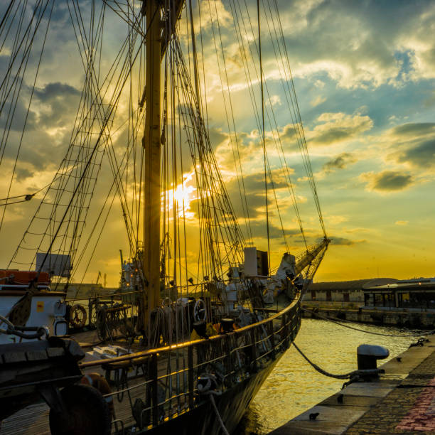 istock Old sailboat anchored with various colored lights . Sunset 1286622611