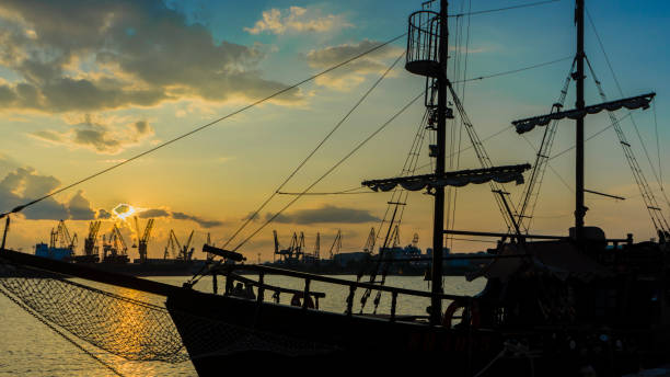 istock Old sailboat anchored with various colored lights . Sunset 1286622702