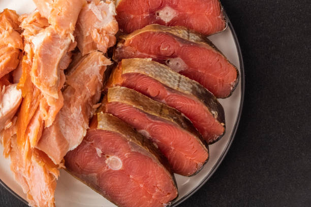 istock Smoked fish on a cup, black background. Beer snack 1286623441