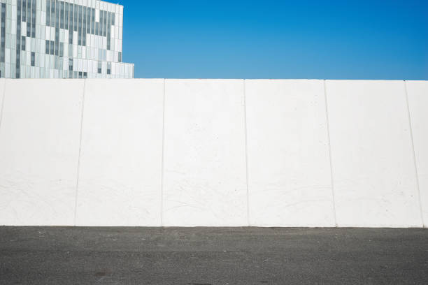 Urban landscape with part of white wide wall. Copy space for text or design
