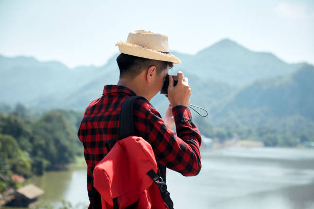 istock Young hipster man traveling with a backpack in summer forest 1286625263