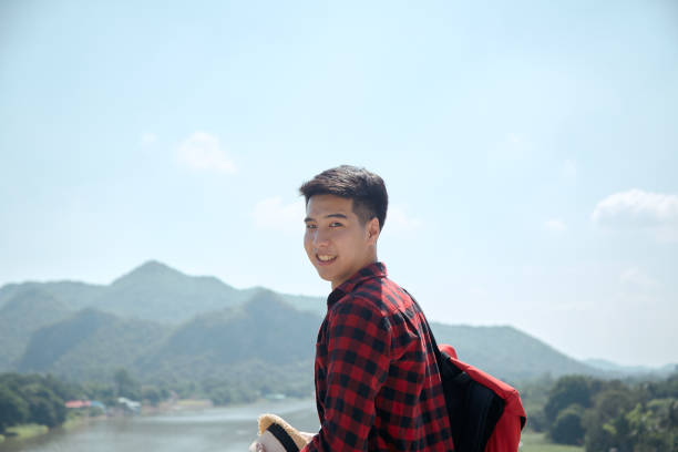 istock Young hipster man traveling with a backpack in summer forest 1286625269