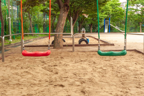 istock Empty chain swings in children playground 1286627836