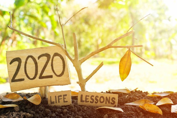 istock A tree branch with a single remaining last leaf hanging beside a 2020 Learning sign at sunset. Life lessons and learnings from the year 2020 concept. 1286628550