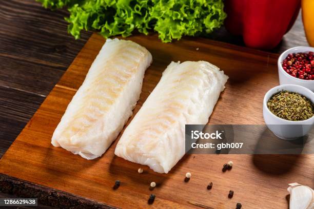 Fresh Raw Cod Fillet On Cutting Board Stock Photo - Download Image Now ...