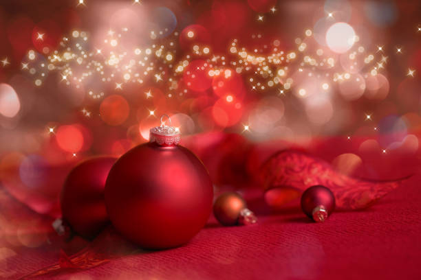 istock Christmas Red Bauble on a Red Defocused Lights Background 1286629534