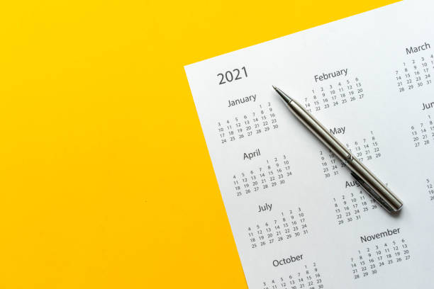istock close up top view on white calendar 2021 schedule on yellow color background to make appointment meeting or manage timetable each day for design planning work and life concept 1286629695