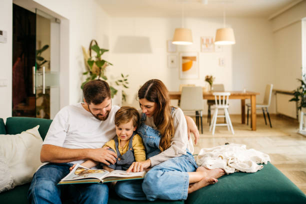 istock Mom and dad reading a book to their son 1286633551
