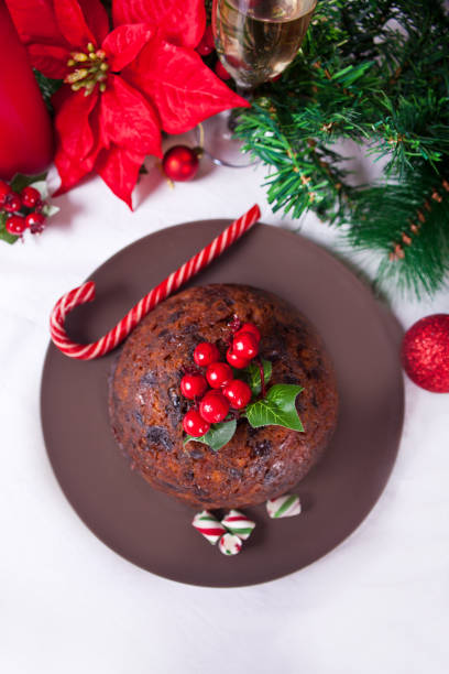 Traditional Christmas pudding with holly on top. stock photo