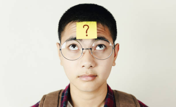 istock Asian teenager and post it note on his face, education and the final exam concept. 1286636858