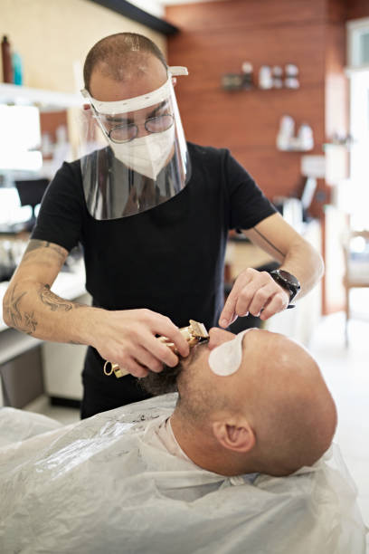 istock Socially Responsible Male Barber Wearing Protective Workwear 1286638801