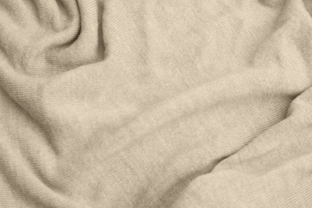 Close up of beige knitted textured background.