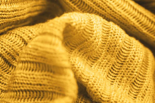 istock Close up of yellow knitted textured background. 1286641486