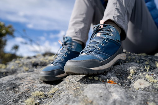Close-up on a woman wearing hiking boots outdoors - lifestyle concepts